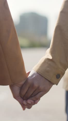 Vertical-Video-Close-Up-Shot-Of-Loving-Muslim-Couple-On-Date-Walking-And-Holding-Hands